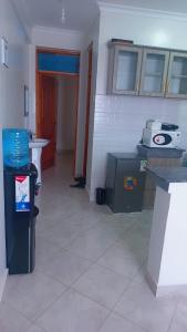 a room with a kitchen with a counter and a table at Panorama bnbs meru in Meru