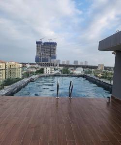 a swimming pool on the roof of a building at LaLa Apartment and Hotel in Danang