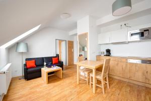 a living room with a couch and a table at BSW Ferienwohnungen Brockenblick in Schulenberg im Oberharz