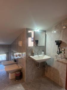 a bathroom with a sink and a toilet at B&B Menta e Rosmarino in Chiassa Superiore