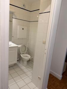 a bathroom with a toilet and a sink at appartement cosy Paris 17eme in Paris