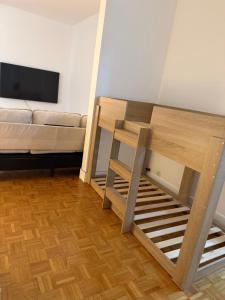 a room with a bed and a couch and a table at appartement cosy Paris 17eme in Paris