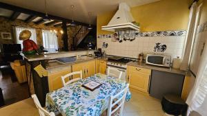 a small kitchen with a table and a microwave at Maison de ville duplex TULLE in Tulle