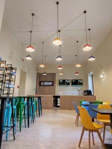 a cafeteria with tables and chairs and lights at Safestay Naples Materdei in Naples