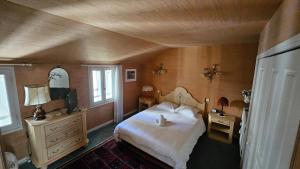a bedroom with a bed and a tv and a window at Maison de ville duplex TULLE in Tulle