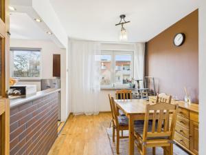 a kitchen and dining room with a table and chairs at Mieszkanie na Alei in Głogów