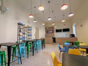 a dining room with tables and chairs at Safestay Naples Materdei in Naples