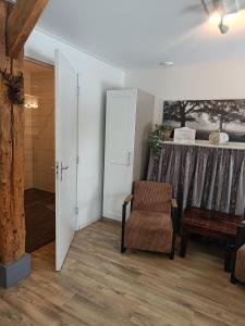 a living room with a chair and a window at Bed And Breakfast Geertruidahoeve in Hellendoorn
