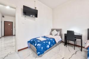a bedroom with a bed and a desk with a computer at Cesare Room in Apartment in Marghera