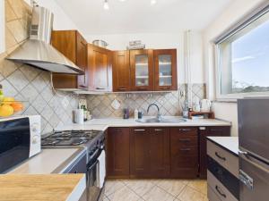 a kitchen with a sink and a stove top oven at Mieszkanie na Alei in Głogów +4 photos