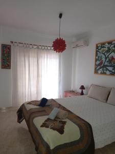 a bedroom with a large bed in a room at Vilamoura Seaside Serenity T3 AP - Pool, BBQ, 3min Walk to Beach in Quarteira +5 photos