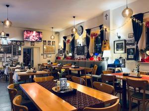a restaurant with tables and chairs and a guitar at KARCZMA-KOSZWICE in Koszwice