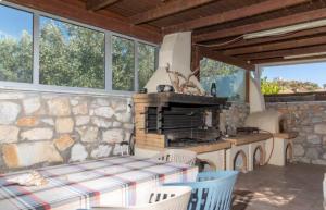 a kitchen with a table and a stone wall at The Stone House Naxos in Glinado Naxos