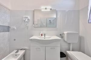 a white bathroom with a sink and a mirror at Cesare Room in Apartment in Marghera +26 photos