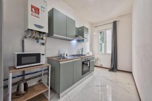 a small kitchen with a sink and a microwave at Cesare Room in Apartment in Marghera