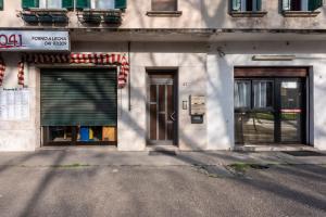 a building with two garage doors on a street at Cesare Room in Apartment in Marghera