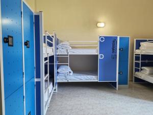 a room with two bunk beds and a door at Safestay Naples Materdei in Naples +69 photos