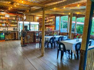 a restaurant with tables and chairs in a room at Zambeze Lodge in Marracuene