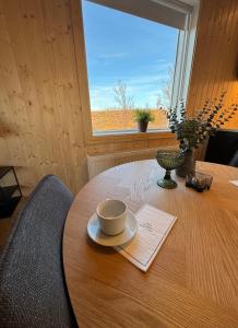 a table with a cup and a plate on it at New listing - Krosshóll Cottage, built in 2026 in Hella +6 photos