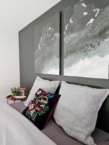 a bedroom with a bed with two pillows on it at Appartement Le petit Bretzel in Neuwiller-lès-Saverne +10 photos