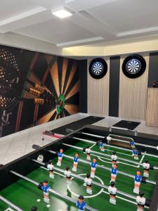 a room with a pool table with people on it at Hotel Weldi in Győr