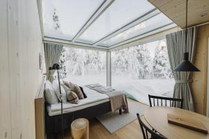 a bedroom with a bed and a large window at Northern Lights Ranch in Levi