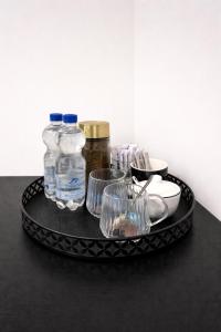 a tray with bottles and glasses on a table at Casaejon in Lelystad