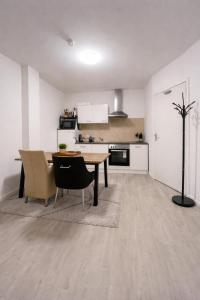 a kitchen and dining room with a table and chairs at Casaejon in Lelystad