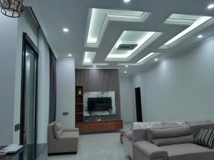 a living room with two couches and a tv at Villa KARISMA Candidasa in Candidasa