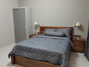 a bedroom with a bed with a gray comforter at Villa KARISMA Candidasa in Candidasa +37 photos