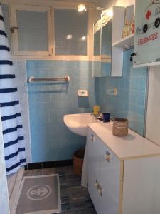 a small bathroom with a sink and a toilet at La bien-aîmée in Ploubazlanec +12 photos