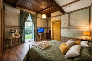 a bedroom with a bed and a tv in it at VesConte Residenza D'epoca dal 1533 in Bolsena +76 photos
