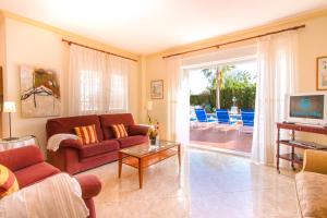 a living room with a couch and a table at Villa La Marina by Abahana Villas in Benissa