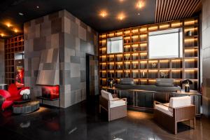 a lobby of a hotel with a fireplace and chairs at CICILIA Rouge Dalat in Da Lat +96 photos
