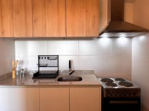 a kitchen with a sink and a stove at Carmelo Postal in Carmelo