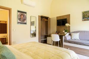 a bedroom with a bed and a couch and a table at Domus Gargilius in Pompei