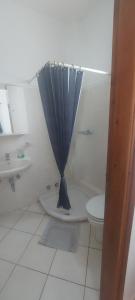 a bathroom with a curtain over a toilet and a sink at Castello Azzurro in Agia Anna Naxos
