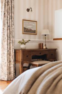 a bedroom with a desk and a bed at Mossie's in Adrigole