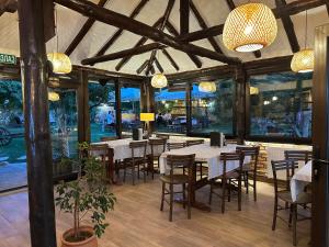 a dining room with tables and chairs and windows at Konak Tosa in Poganovo +83 photos