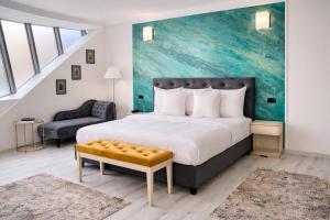 a bedroom with a large bed and a chair at Hotel Paradis in Cluj-Napoca
