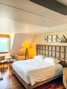 a bedroom with a large bed and a chair at Rivage Hotel Restaurant Lutry in Lausanne +47 photos