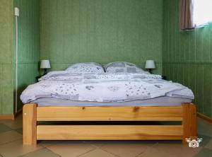 a bedroom with a bed with a white comforter at Domek 57m2 - max 5 osób - NR4 in Ciężkowice
