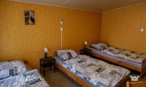 two beds in a room with yellow walls at Domek 57m2 - max 5 osób - NR4 in Ciężkowice +5 photos