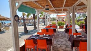 a restaurant on the beach with tables and chairs at Beach Club Ippocampo in Ippocampo