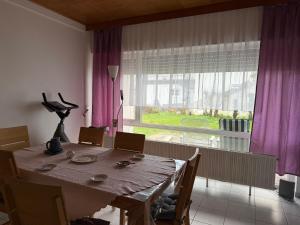 a dining room with a table and a large window at Sonnenblick Kleiberweg in Mosbach