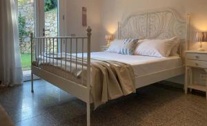 a bedroom with a white bed and a window at Villa Terrazza sul Mare in Budoni +13 photos