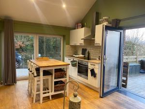 a kitchen with a counter and a table in it at L'île d'Amélie in Ciney