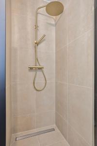 a shower with a shower head in a bathroom at Eindhoven City Suites Hoogstraat B 4P in Eindhoven