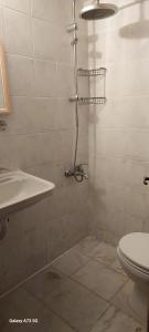 a bathroom with a shower with a toilet and a sink at Haluk Otel in Oren +61 photos
