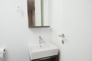 a bathroom with a white sink and a mirror at Luxury Homes Pašman in Pašman +19 photos